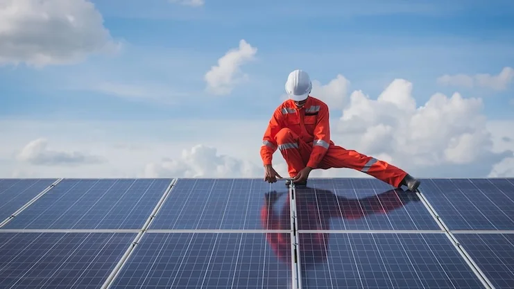 Technician installs solar panel