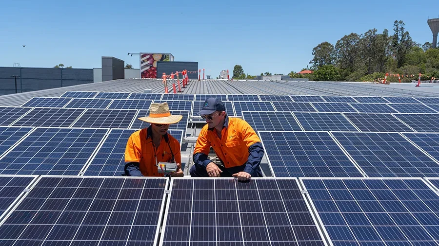 Volteam staff works on solar panel