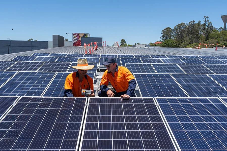 Volteam staff works on solar panel