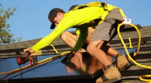 Two men on a roof installing solar panels